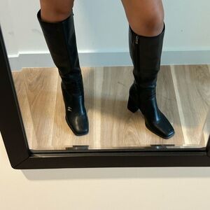 Sleek Black Heeled Boots with Classic Design